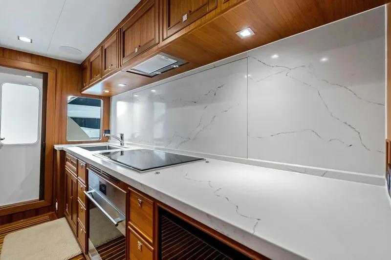 Slide: The Image of Luxurious kitchen in 2024 Marlow 90 V yacht with sleek countertops and modern appliances. - 21