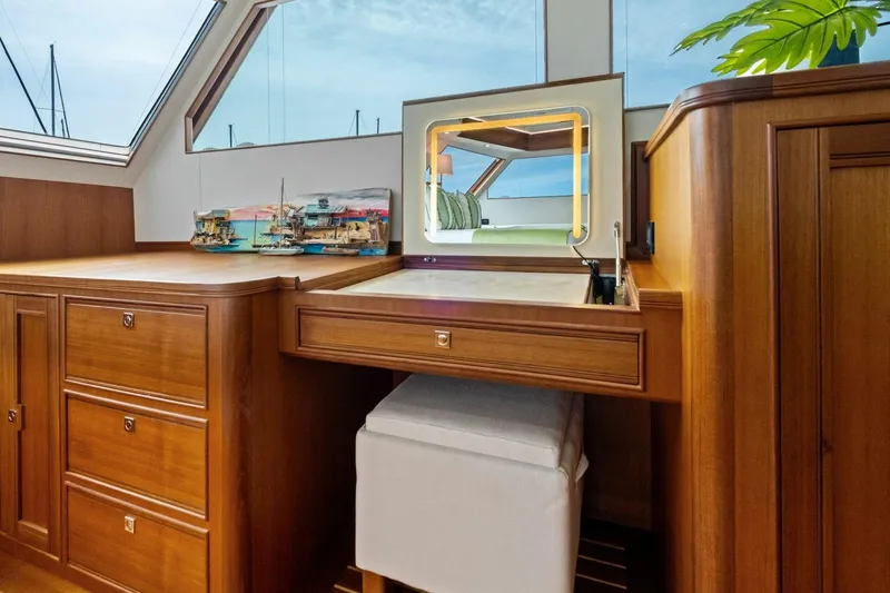 Slide: The Image of Luxurious wooden interior of 2024 Marlow 90 V yacht with vanity and model ships. - 27