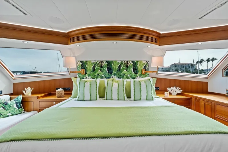 Slide: The Image of Luxurious 2024 Marlow 90 V yacht bedroom with green accents and large windows. - 29