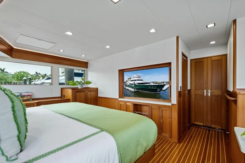 Slide: The Image of Luxurious bedroom interior of 2024 Marlow 90 V yacht with elegant wood finishes. - 31