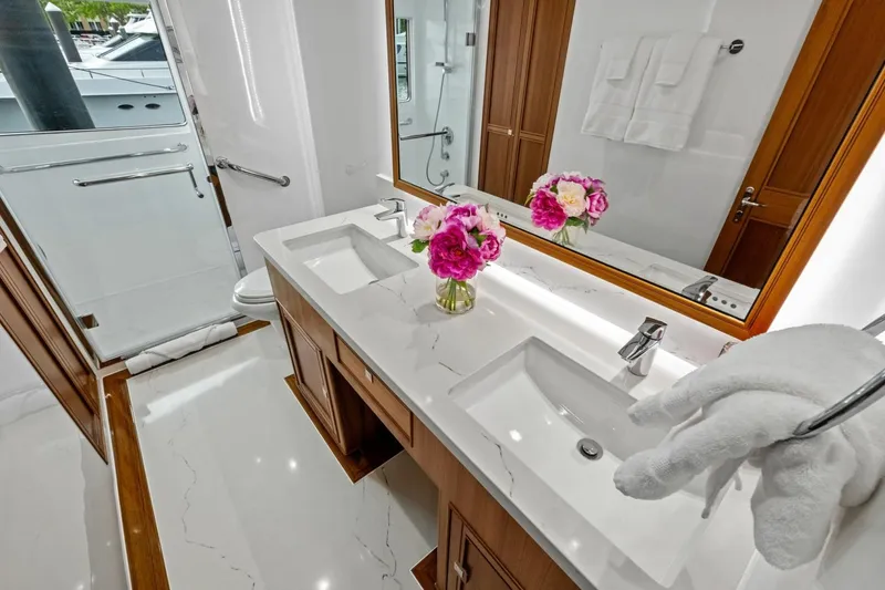 Slide: The Image of Luxurious 2024 Marlow 90 V yacht bathroom with dual sinks and elegant decor. - 32
