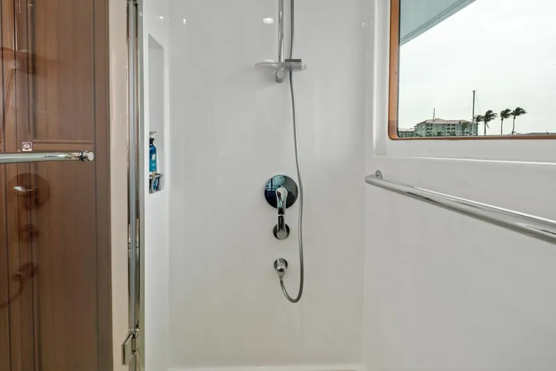 Slide: The Image of Luxurious shower area in 2024 Marlow 90 V yacht with modern fixtures and window view. - 35
