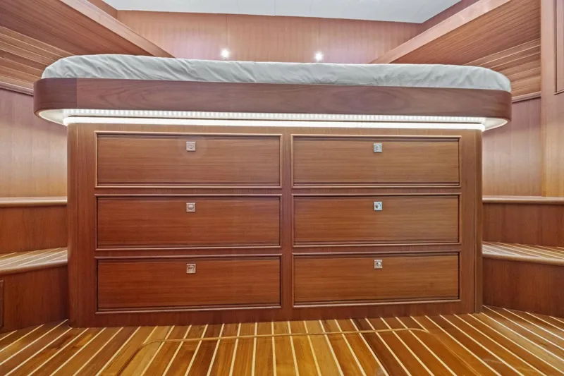 Slide: The Image of Luxurious wooden interior of 2024 Marlow 90 V yacht with built-in storage drawers. - 38
