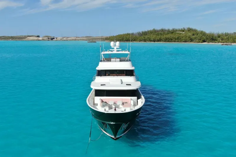 Slide: The Image of Luxury 2024 Marlow 90 V yacht anchored in crystal-clear turquoise waters. - 4