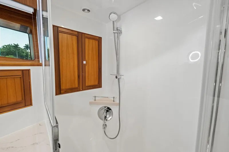 Slide: The Image of Luxurious shower area in 2024 Marlow 90 V yacht with wooden accents. - 42
