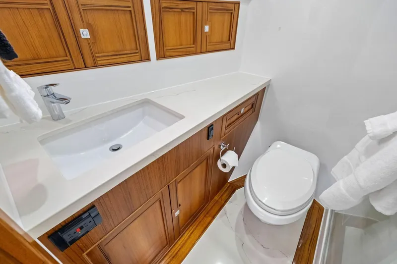 Slide: The Image of Luxurious bathroom in 2024 Marlow 90 V yacht with wooden cabinetry and modern fixtures. - 44