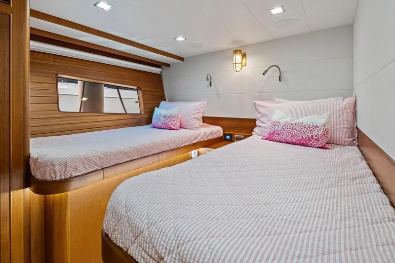 Slide: The Image of Luxurious twin cabin in 2024 Marlow 90 V yacht with elegant wood paneling. - 47