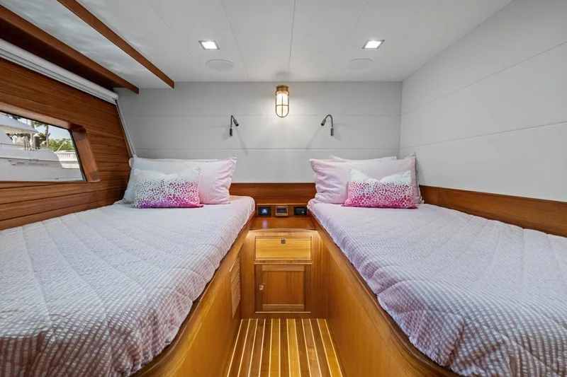 Slide: The Image of Luxurious twin cabin in 2024 Marlow 90 V yacht with elegant wood finish. - 48