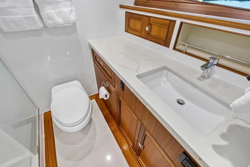 Slide: The Image of Luxurious bathroom in 2024 Marlow 90 V yacht with modern fixtures and wooden cabinetry. - 50