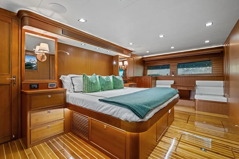 Slide: The Image of Luxurious 2024 Marlow 90 V yacht bedroom with elegant wood finishes and modern decor. - 54