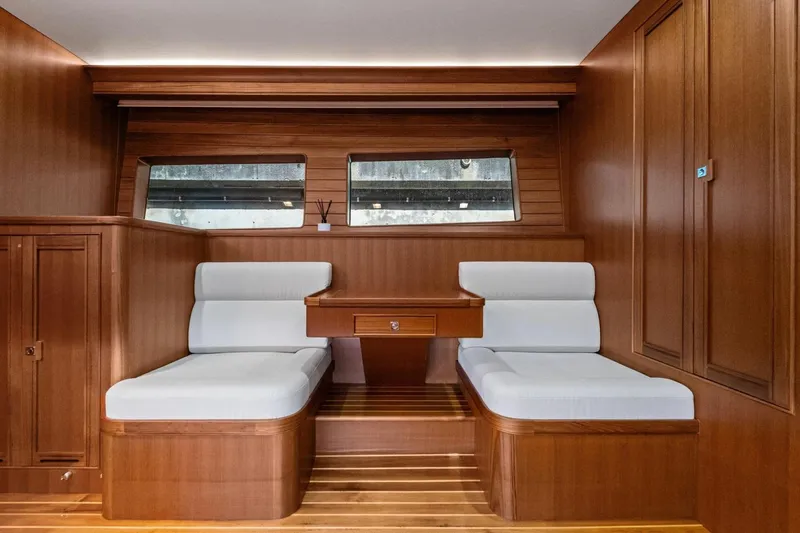 Slide: The Image of Luxurious 2024 Marlow 90 V yacht interior with elegant wood paneling and comfortable seating. - 57