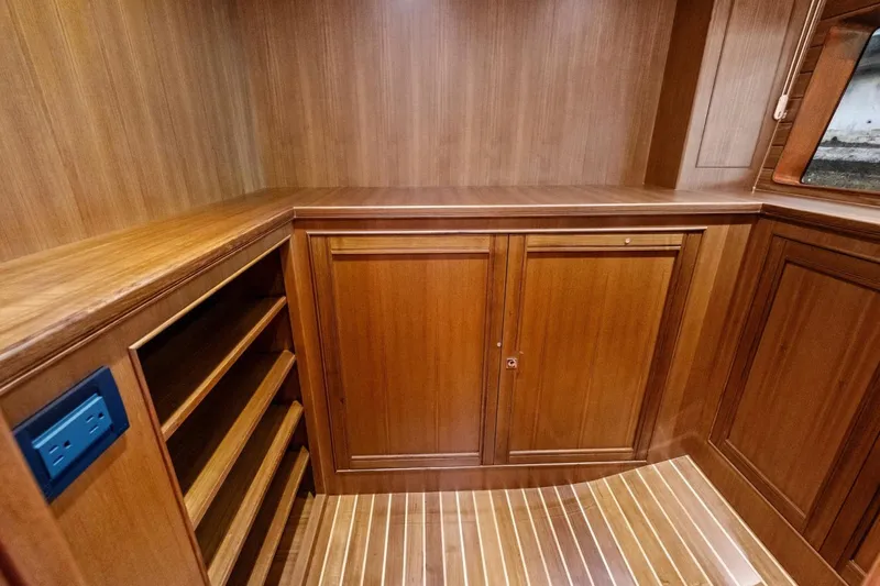 Slide: The Image of Luxurious wooden interior of 2024 Marlow 90 V yacht with shelving and cabinetry. - 59