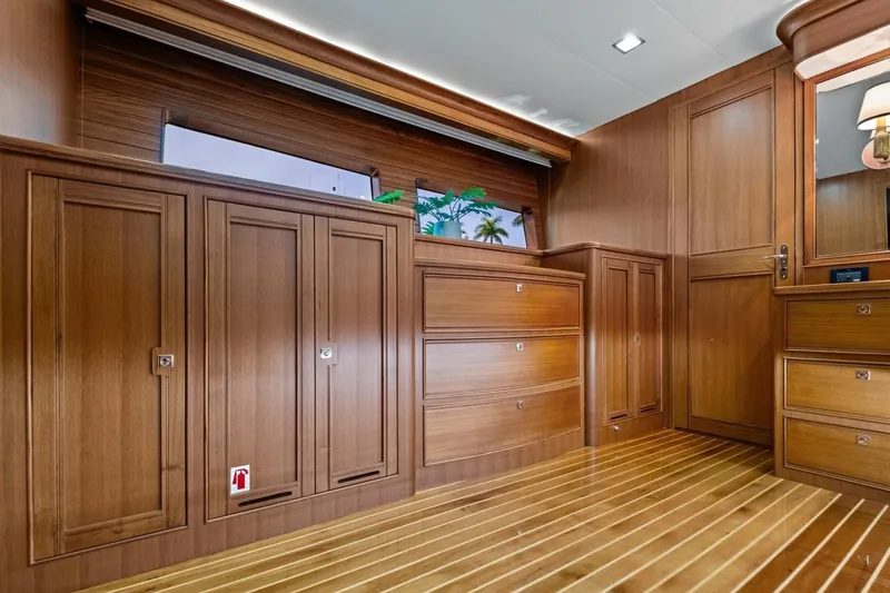 Slide: The Image of Luxurious wooden interior of 2024 Marlow 90 V yacht, featuring elegant cabinetry and flooring. - 60