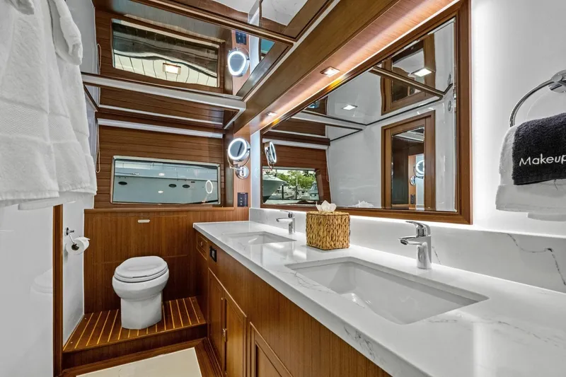 Slide: The Image of Luxurious 2024 Marlow 90 V yacht bathroom with dual sinks and elegant wood accents. - 61