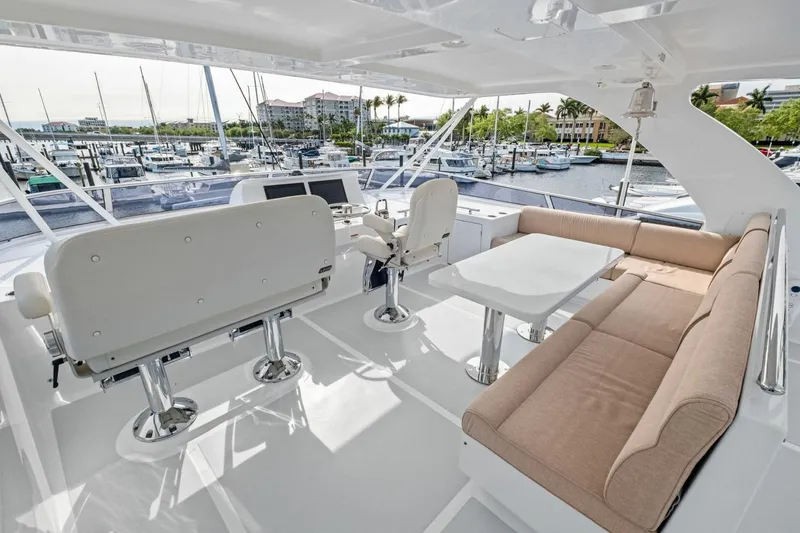 Slide: The Image of Luxurious 2024 Marlow 90 V yacht deck with seating and marina view. - 69
