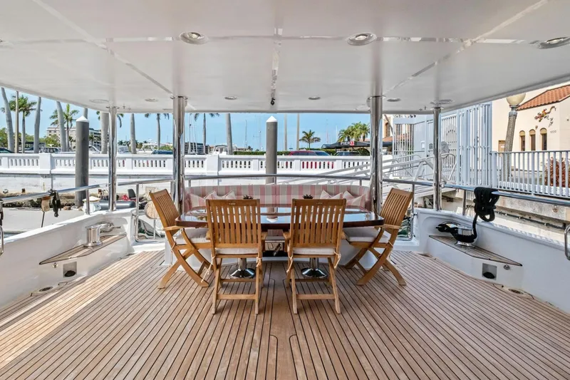 Slide: The Image of Luxury yacht Marlow 90 V 2024 with elegant outdoor dining area and wooden deck. - 74