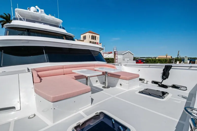 Slide: The Image of Luxury 2024 Marlow 90 V yacht deck with pink seating and table. - 79