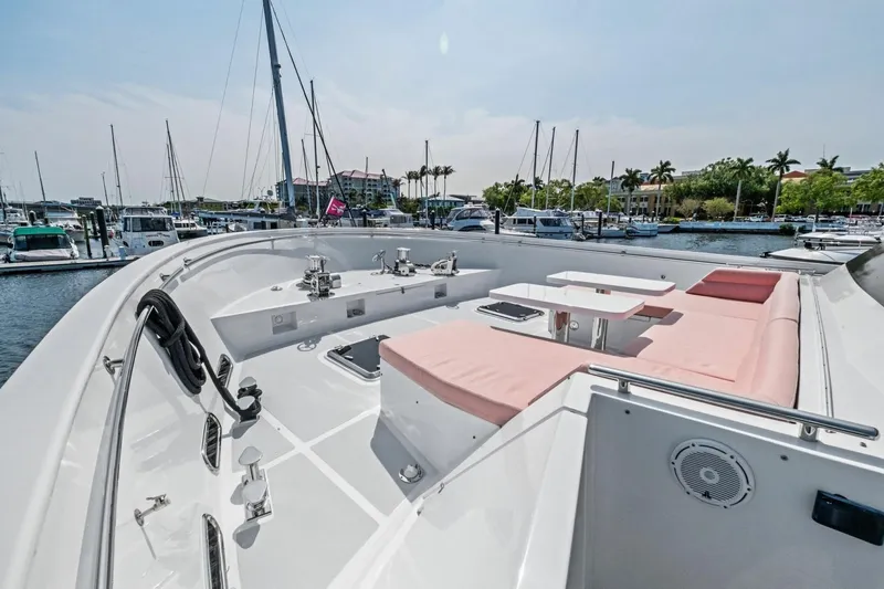 Slide: The Image of Luxurious 2024 Marlow 90 V yacht deck with seating and marina view. - 80