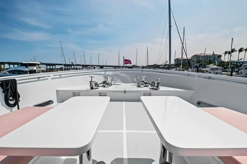 Slide: The Image of Luxurious 2024 Marlow 90 V yacht deck with seating and marina view. - 82