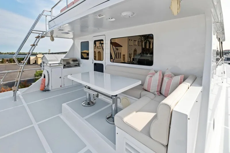 Slide: The Image of Luxurious 2024 Marlow 90 V yacht deck with seating, table, and grill. - 84