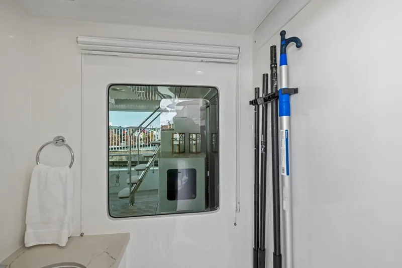 Slide: The Image of Interior view of 2024 Marlow 90 V yacht with window and cleaning tools. - 86