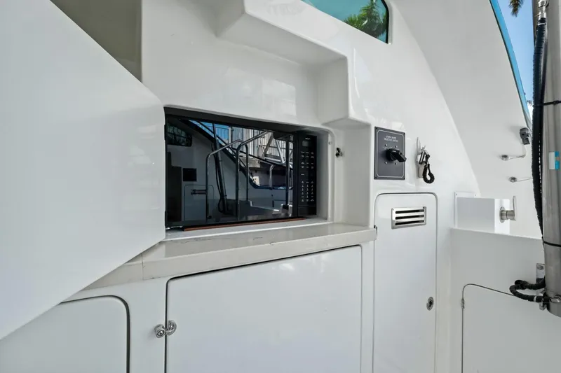 Slide: The Image of Interior view of 2024 Marlow 90 V yacht featuring a built-in microwave. - 92
