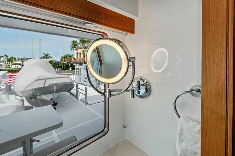 Slide: The Image of Luxury yacht Marlow 90 V 2024 bathroom with illuminated mirror and marina view. - 94