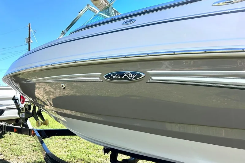 Slide: The Image of 2009 Sea Ray 210 boat on trailer, side view with logo visible. - 11