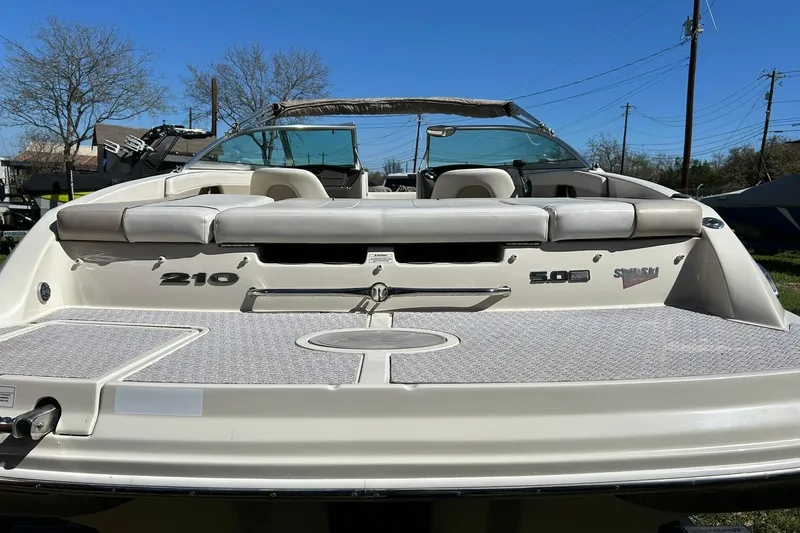 Slide: The Image of 2009 Sea Ray 210 boat with spacious seating and sleek design. - 17