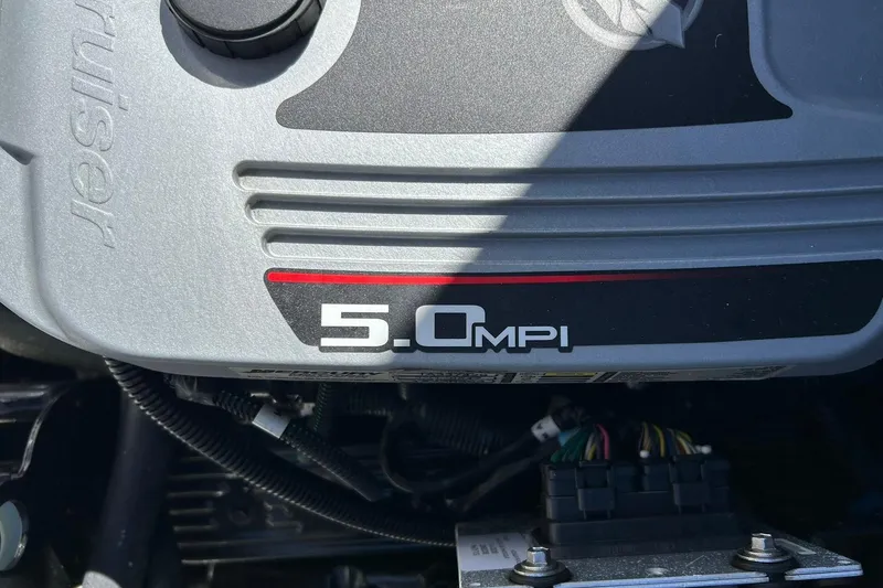 Slide: The Image of Engine cover of a 2009 Sea Ray 210 with 5.0 MPI branding. - 21