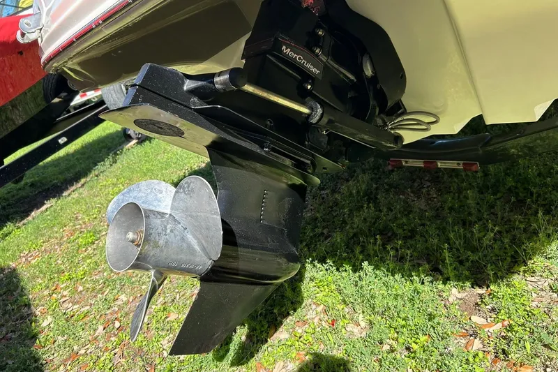 Slide: The Image of 2009 Sea Ray 210 boat with MerCruiser outdrive and propeller on grass. - 24