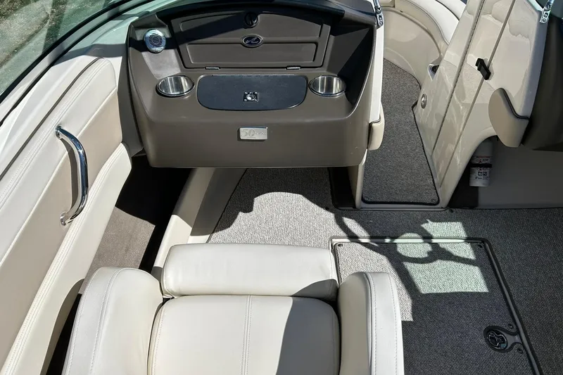 Slide: The Image of Interior of a 2009 Sea Ray 210 boat with beige seating and carpet. - 28