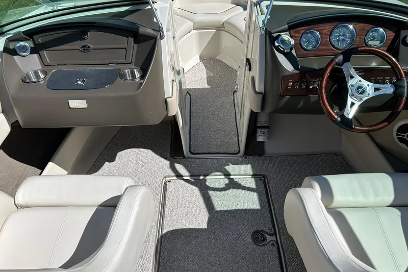 Slide: The Image of Interior of 2009 Sea Ray 210 boat with steering wheel and seating. - 29