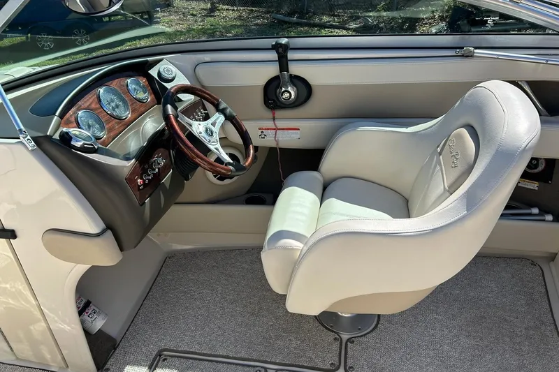 Slide: The Image of 2009 Sea Ray 210 boat interior with steering wheel and dashboard. - 31