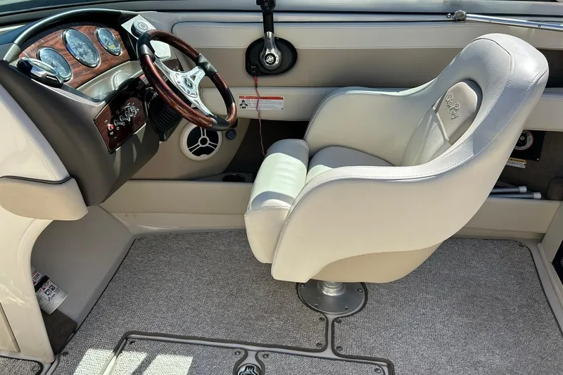 Slide: The Image of Interior of 2009 Sea Ray 210 boat with steering wheel and captain's chair. - 32