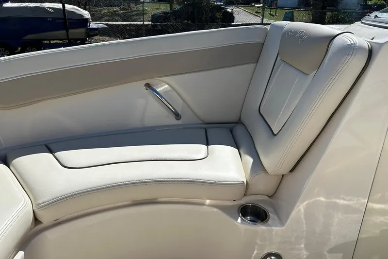 Slide: The Image of Luxurious seating on a 2009 Sea Ray 210 boat, featuring white leather upholstery. - 35