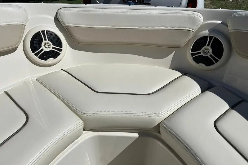 Slide: The Image of Interior seating of a 2009 Sea Ray 210 boat with built-in speakers. - 37