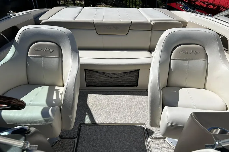 Slide: The Image of Interior of a 2009 Sea Ray 210 boat with beige leather seats. - 4