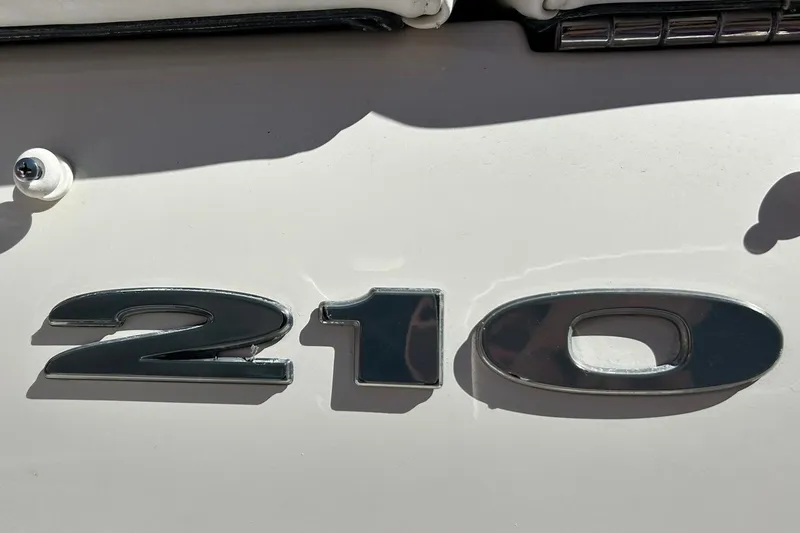 Slide: The Image of Close-up of 2009 Sea Ray 210 model emblem on boat exterior. - 43
