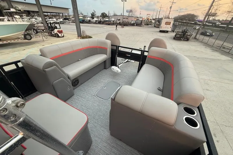 Slide: The Image of 2022 Apex Marine 8524 Pro Fish N Cruise pontoon boat interior with gray seating and cup holders. - 11