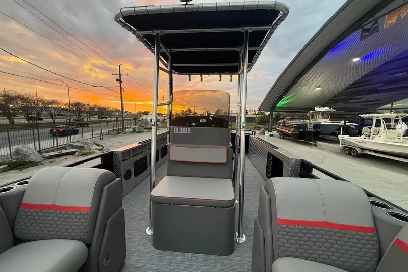 Slide: The Image of 2022 Apex Marine 8524 Pro Fish N Cruise boat at sunset, showcasing seating and helm. - 13