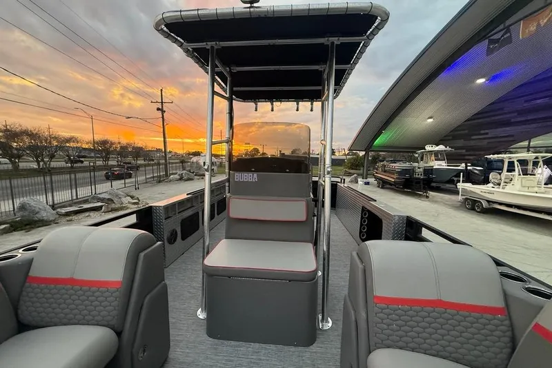 Slide: The Image of 2022 Apex Marine 8524 Pro Fish N Cruise boat at sunset, showcasing seating and canopy. - 14