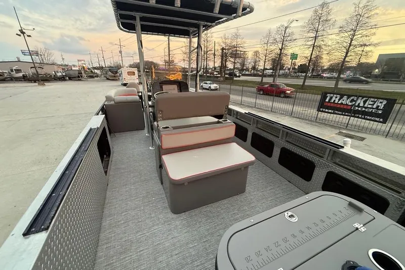 Slide: The Image of 2022 Apex Marine 8524 Pro Fish N Cruise pontoon boat interior at sunset. - 23
