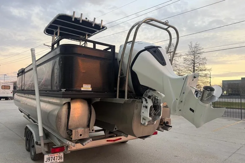 Slide: The Image of 2022 Apex Marine 8524 Pro Fish N Cruise pontoon boat on trailer at sunset. - 4