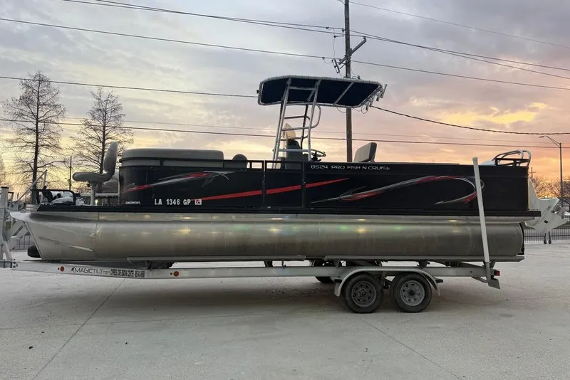 Slide: The Image of 2022 Apex Marine 8524 Pro Fish N Cruise pontoon boat on trailer at sunset. - 5