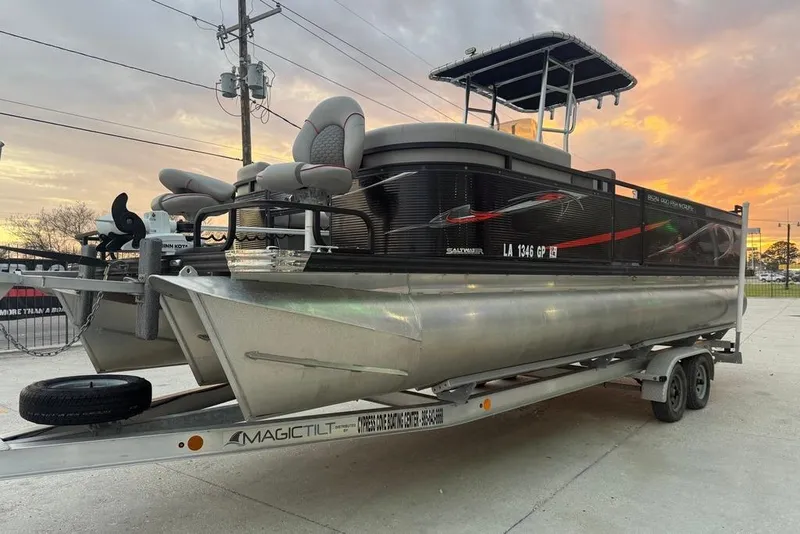 Slide: The Image of 2022 Apex Marine 8524 Pro Fish N Cruise pontoon boat on trailer at sunset. - 6