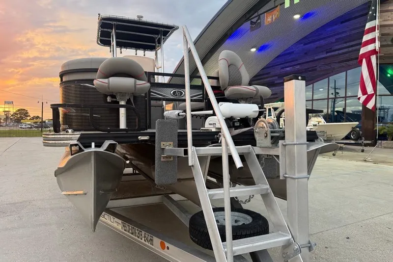 Slide: The Image of 2022 Apex Marine 8524 Pro Fish N Cruise pontoon boat on trailer at sunset. - 7