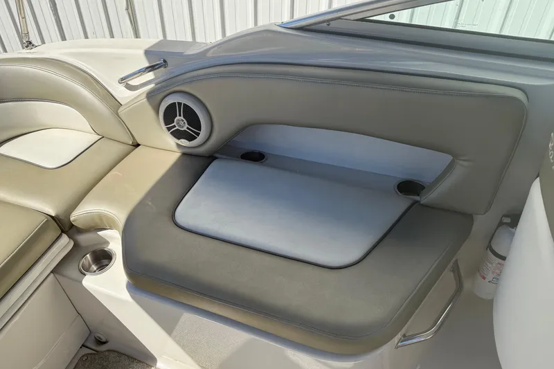 Slide: The Image of 2007 Sea Ray 270 Sundeck interior seating with speaker and cup holder. - 10