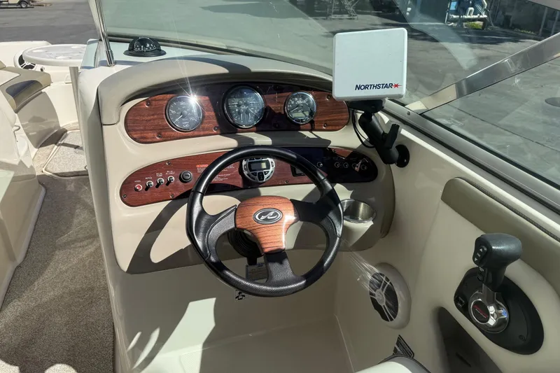 Slide: The Image of 2007 Sea Ray 270 Sundeck dashboard with steering wheel and navigation system. - 12