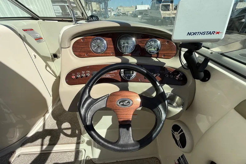 Slide: The Image of 2007 Sea Ray 270 Sundeck dashboard with steering wheel and gauges. - 13